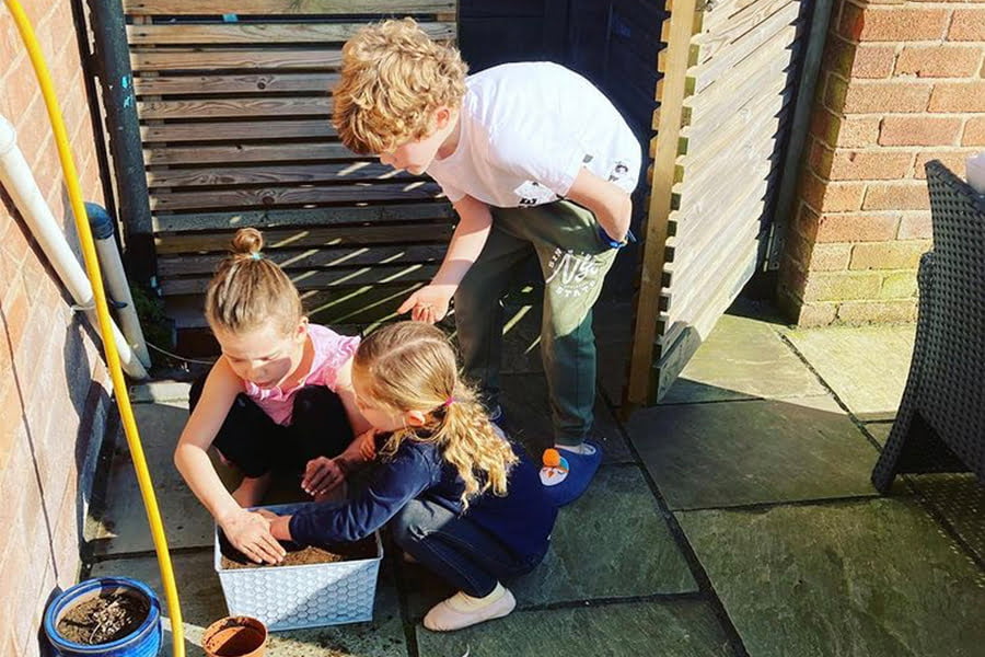 My children sowing wildflowers, excited to watch them germinate in the coming weeks and see them flower throughout the summer.